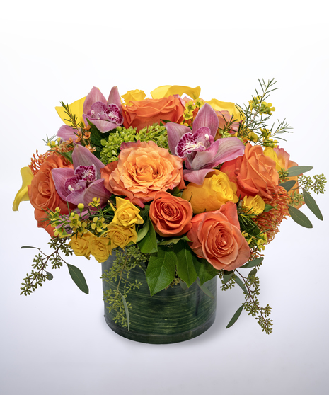 orange yellow and pink flowers in a stunning green vase